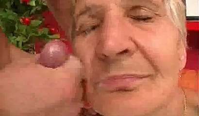 Horny grandma jerks off with her dentures